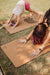 mom and kid enjoying yoga in nature with a downward facing dog pose on Lauryan cork yoga mats for adults and yoga child mat