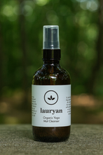 Load image into Gallery viewer, Bottle of Lauryan Organic Yoga Mat Cleanser with a white label against a blurred green background